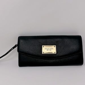 wristlet leather in perfect condition, emblem has very light scuffs.